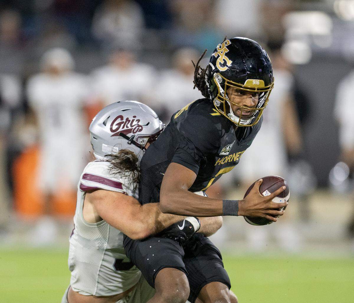 Sacramento State Hornets quarterback Cardell Williams (7) is sacked by Montana Grizzlies linebacker Peyton Wing (32) in the second half on Friday, Oct. 24, 2025, in Sacramento.
