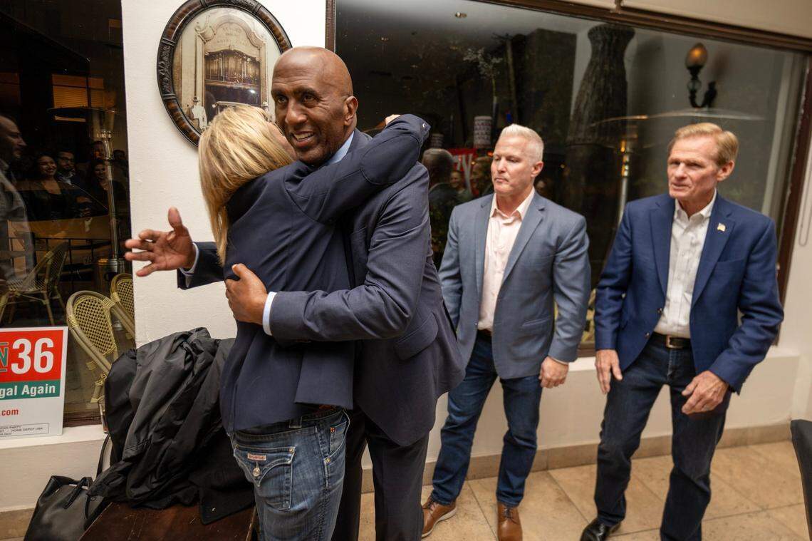 Sacramento Sheriff Jim Cooper embraces Anne Marie Schubert, co-chair of the Californians for Safer Communities coalition and former Sacramento District Attorney, after early results of Proposition 36 were announced on Tuesday, Nov. 5, 2024, during an Election Night party at Zocalo in midtown Sacramento. Jeff Reisig, Yolo County district attorney, and Greg Totten, co-chair of Californians for Safer Communities, stand at right.
