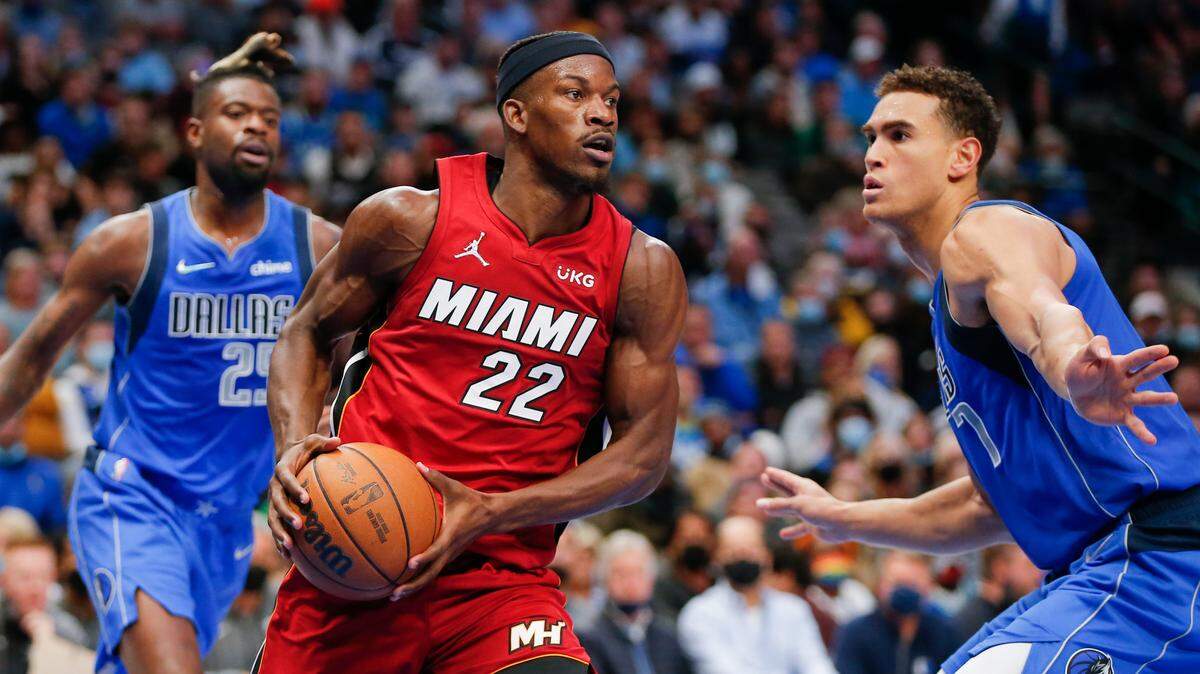 Miami Heat forward Jimmy Butler (22) is defended by Dallas Mavericks center Dwight Powell (7) during the second half of an NBA basketball game Tuesday, Nov. 2, 2021, in Dallas. Miami won 125-110. (AP Photo/Brandon Wade)