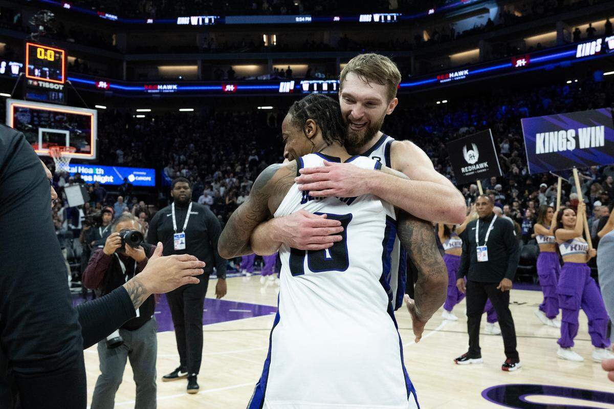 Sacramento Kings center Domantas Sabonis (11) hugs Sacramento Kings forward DeMar DeRozan (10) after beating the Miami Heat in double overtime during an NBA game at Golden 1 Center on Monday, Jan. 6, 2025, in Sacramento.