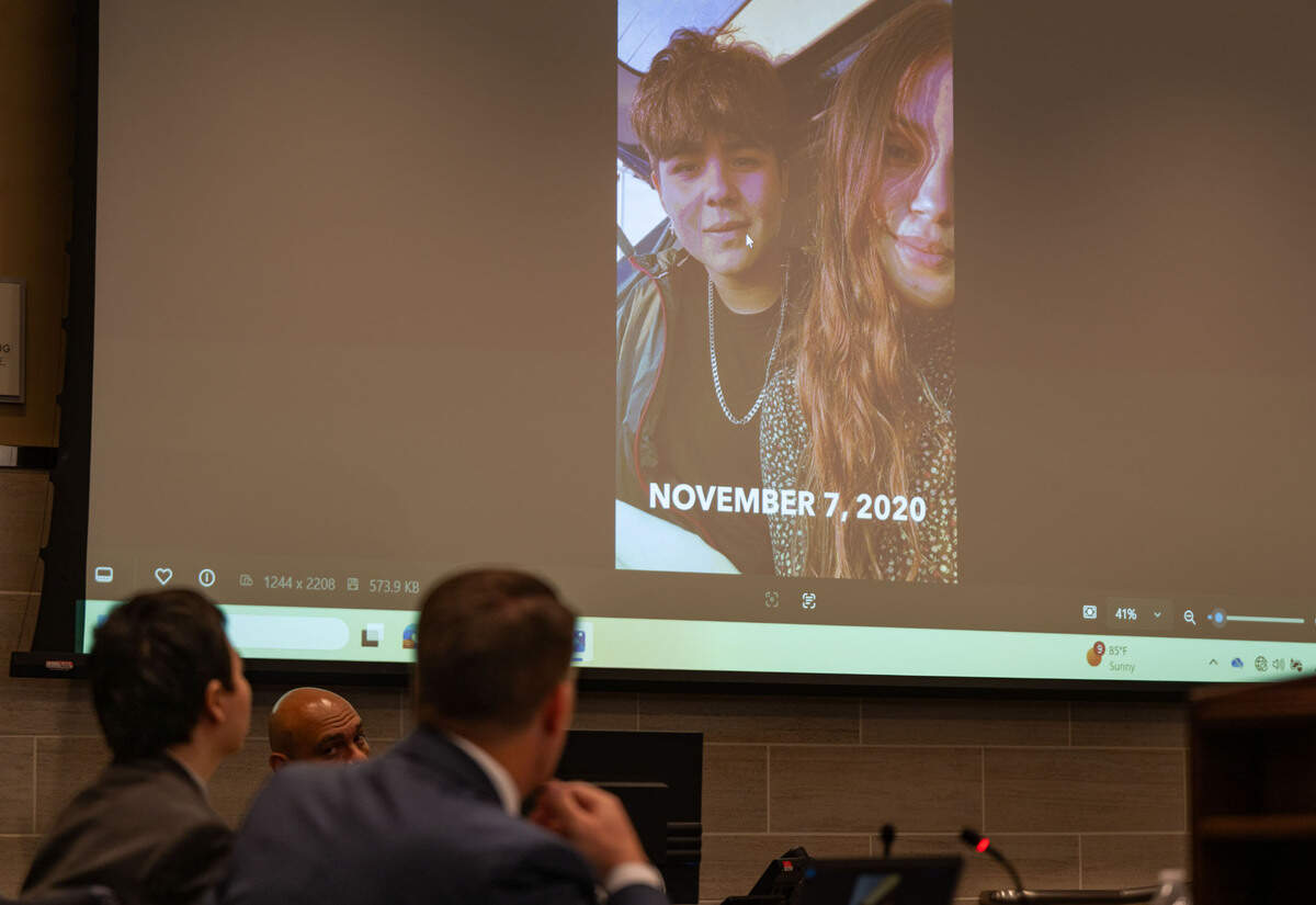 Carlos Reales Dominguez and public defender Daniel Hutchinson look a photo of Dominguez and his former girlfriend Caley Gallardo as she testifies in Yolo Superior Court in Woodland on Monday. The image shows the two on campus at UC Davis in November 2020, before they officially became a couple. Dominguez is accused of murdering two and injuring a third in a series of knife attacks in Davis.