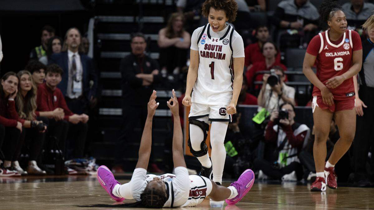 South Carolina Gamecocks guard Maddy McDaniel (1) celebrates with guard Ta'niya Latson (00) after making a 3-point shot in the first half against the Oklahoma Sooners in an NCAA Women’s Basketball Tournament Sweet 16 game Saturday at Golden 1 Center in Sacramento.