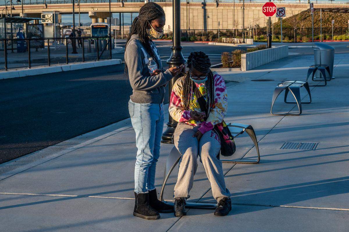 Danaya Watts, 14, left, and her sister Daisha Watts, 19, wait for their father Quentin Watts at the Vacaville/ Fairfield Amtrak station where security guards at California State Prison-Solano in Vacaville said he would be released after serving almost 12 years in prison.