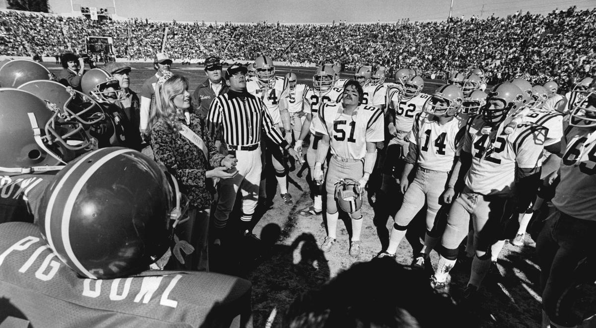 About 28,500 people – including Miss Sacramento 1979 Michelle E. Armtrout – watch the coin flip before Pig Bowl VI game at Hughes Stadium on Jan. 19, 1980.