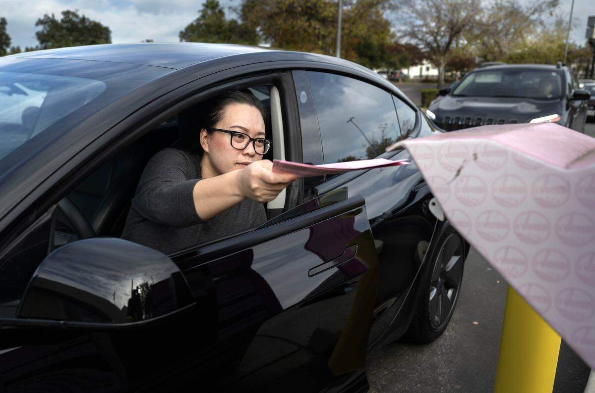 Vivian Yee, of Sacramento, drops off her ballot at the Sacramento County Voter Registration and Elections drop box on Tuesday, Nov. 4, 2025.