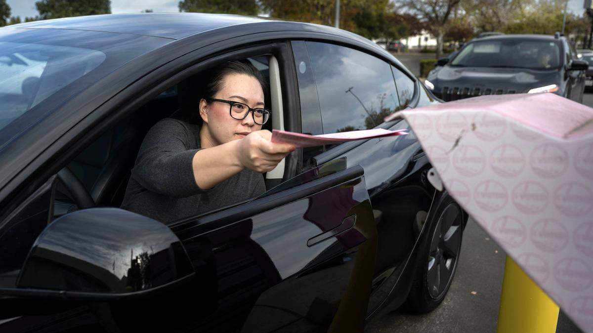 Vivian Yee, of Sacramento, drops off her ballot at the Sacramento County Voter Registration and Elections drop box on Tuesday, Nov. 4, 2025. 