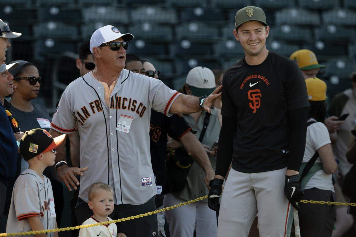 San Francisco Giants catcher Daniel Susac meets with family before the game Friday against the Athletics at Sutter Health Park in West Sacramento.