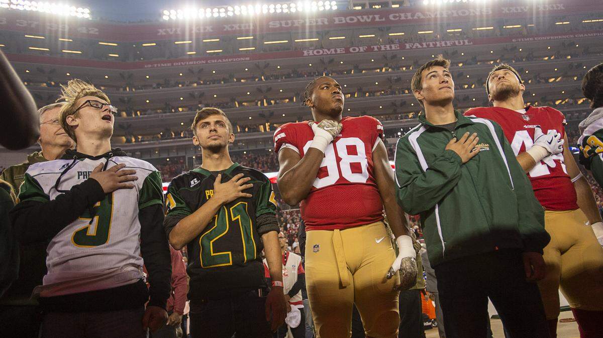 Paradise High School students Kaleb Nelson, Austyn Swartz and Sam Gieg share the field with the San Francisco 49ers during a game at Levi’s Stadium on Monday, November 12, 2018 in Santa Clara.