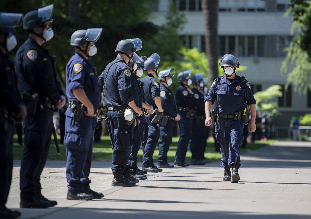 California Highway Patrol officers guard the state Capitol grounds during a protest against Gov. Gavin Newsom’s coronavirus stay-at-home order on Thursday, May 6, 2020 in Sacramento.