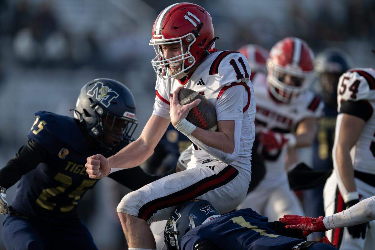 The Winters Warriors' Lane Brown (11) runs in for a touchdown in the first half against the Morse Tigers in the CIF Division 6-A State Championship football game at Buena Park High School in Buena Park on Saturday.
