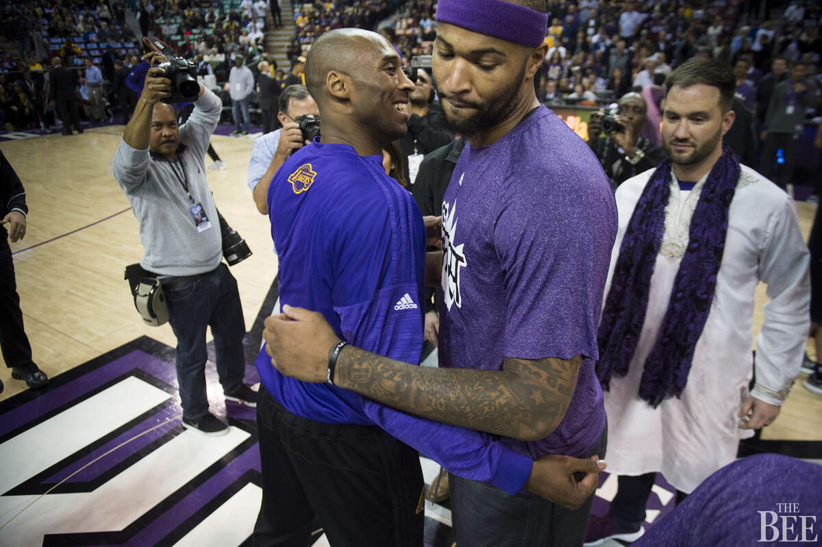 Los Angeles Lakers forward Kobe Bryant (24) hugs Sacramento Kings forward DeMarcus Cousins (15) before their game.