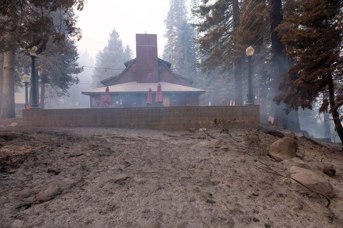A lodge building stands at Camp Sacramento on Monday after firefighters worked through the night to save the beloved recreation site from the Caldor Fire.