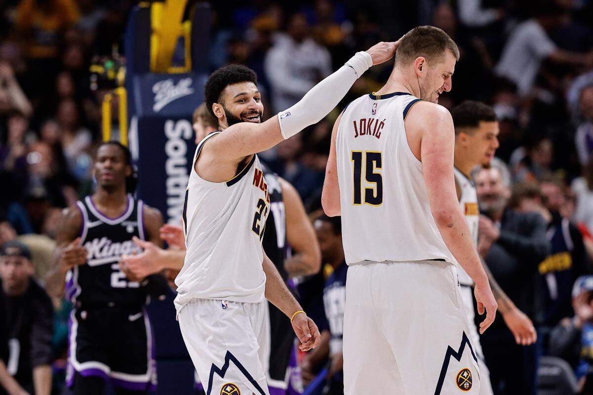 Denver Nuggets guard Jamal Murray (27) reacts with center Nikola Jokic (15) in the third quarter against the Sacramento Kings on Wednesday, Feb. 28, 2024, at Ball Arena in Denver, Colorado.