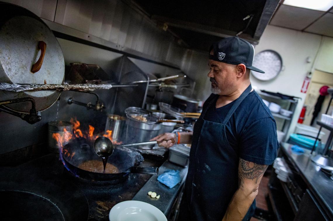 Michael Helmrich, owner of The Mandarin, prepares the establishment’s signature spicy garlic shrimp in wine sauce, Wednesday, Dec. 4, 2019. His parents opened the restaurant in 1981 and the dish’s recipe hasn’t changed since then.