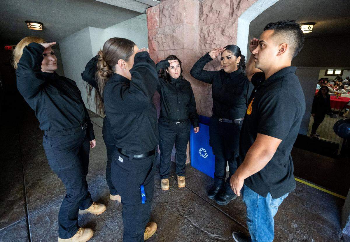 Future Fire Academy founder Anthony Pedro instructs members of a firefighting training program for female inmates how to salute the flag on Tuesday before their graduation ceremony in Sacramento. The five women were the first all-female group to graduate from the program.