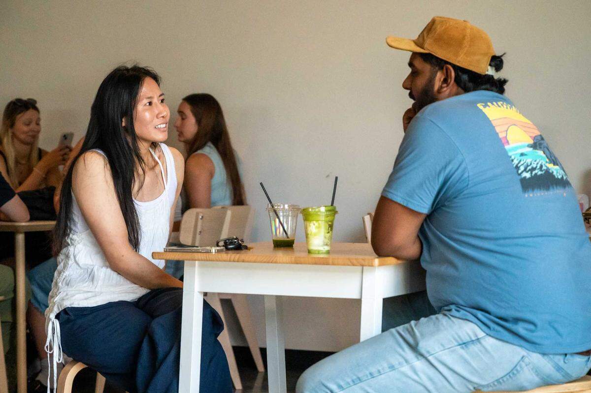 Jenny Huynh (left) and Kal Kumar (right) have a conversation over matcha at Chloe Ca Phe in midtown on Saturday, July 12, 2025.