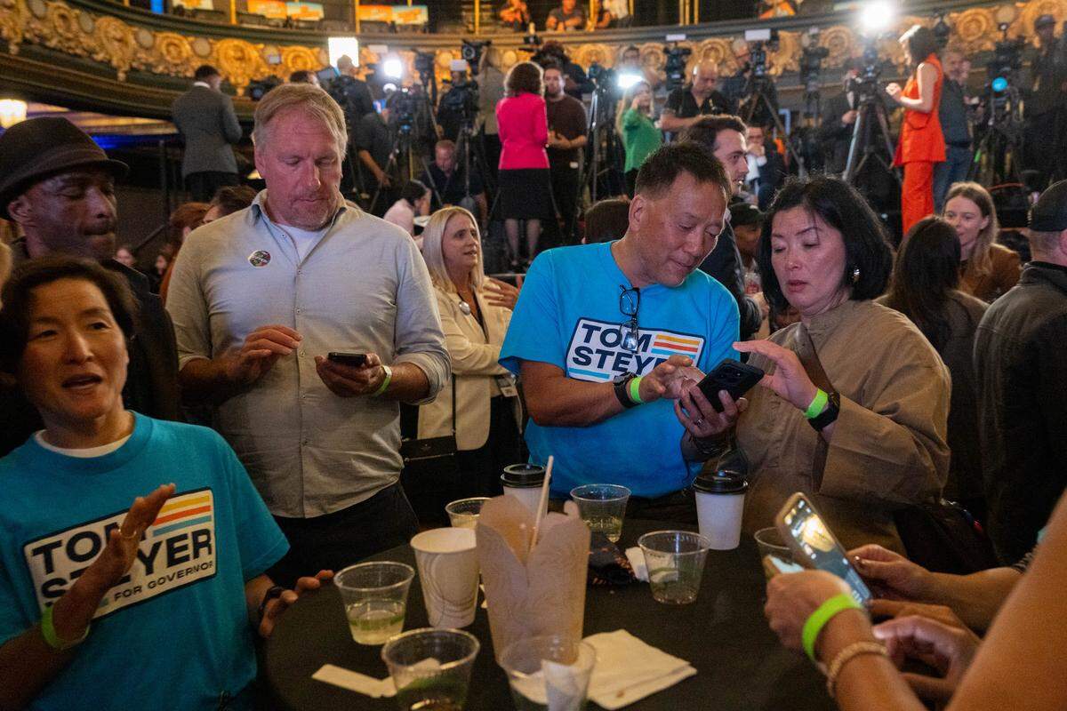 California gubernatorial candidate Tom Steyer's supporters look at poll results during a election night watch party at the Regency Ballroom in San Francisco on Tuesday.