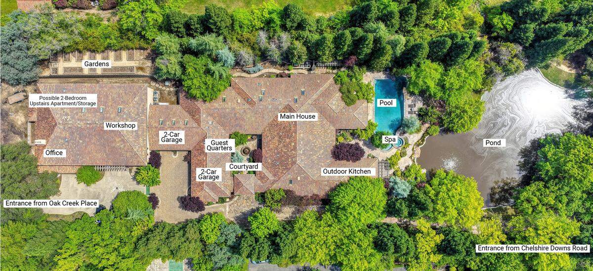 The private gated estate spans 2.5 flat acres with park-like landscaping, water features and a resort-style backyard that feels worlds away from the center of town.