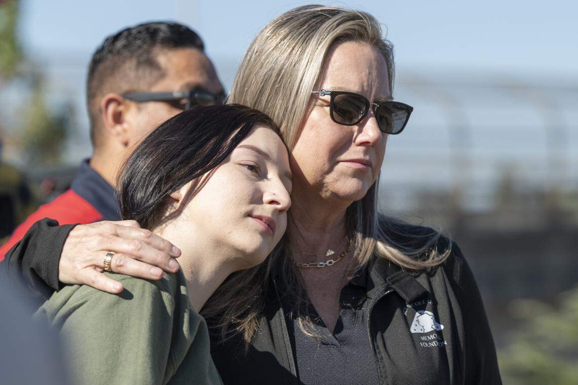 Cheryl Juels hugs Krista Juels on Wednesday as they watch a sign dedicating a portion of Interstate 80 to their relative Sgt. Nicole Gee be unveiled in Roseville. Cheryl Juels says after her niece Gee’s mother died, she acted as a parent to Gee, who was killed during the U.S. withdrawal from Afghanistan in 2021.