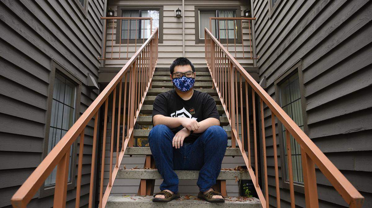 Jordan Yang, 19, sits on a stairway outside at his Pocket area apartment Friday, Nov. 19, 2021, provided by Aspiranet, a statewide organization that offers services to youth and young adults to help them with stable housing, employment, education advancement, and life guidance. Aspiranet is asking Book of Dreams readers for donations to purchase metal foldable shopping carts for young adults between the ages of 18 and 21 who have recently aged out of the state foster care system.