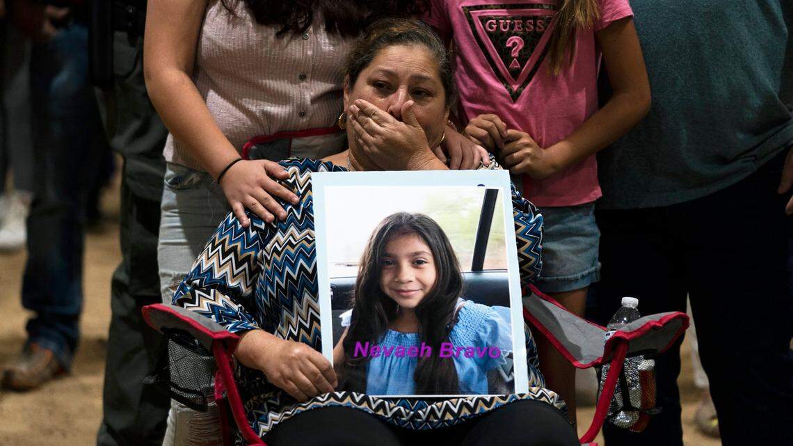 Esmeralda Bravo, 63, sheds tears while holding a photo of her granddaughter, Nevaeh, one of the Robb Elementary School shooting victims, during a prayer vigil in Uvalde, Texas, Wednesday, May 25, 2022.