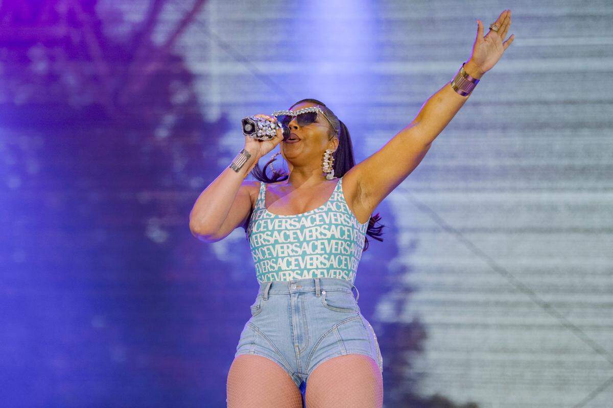 Singer Ashanti raises an arm the sky in an outdoor concert at Cal Expo during the California State Fair on Wednesday night.