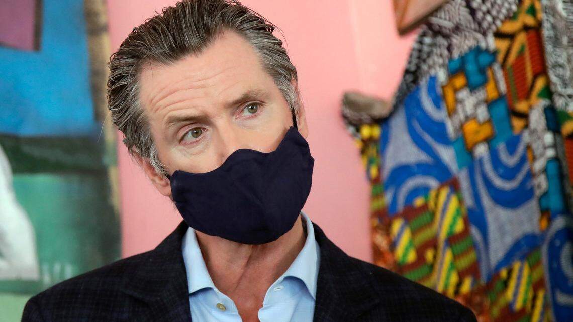FILE - In this June 9, 2020, file photo, California Gov. Gavin Newsom wears a protective mask on his face while speaking to reporters at Miss Ollie’s restaurant during the coronavirus outbreak in Oakland, Calif. Following a weekend that allowed California’s broadest reopening yet, Newsom on Monday, June 15, 2020, defended the state’s pace of easing coronavirus restrictions and said the economic harm they inflicted have negative health outcomes, too. “We have to recognize you can’t be in a permanent state where people are locked away for months and months and months and months on end,” he said, adding the state must consider the health impacts of seeing “lives and livelihoods completely destroyed. (AP Photo/Jeff Chiu, Pool, File)