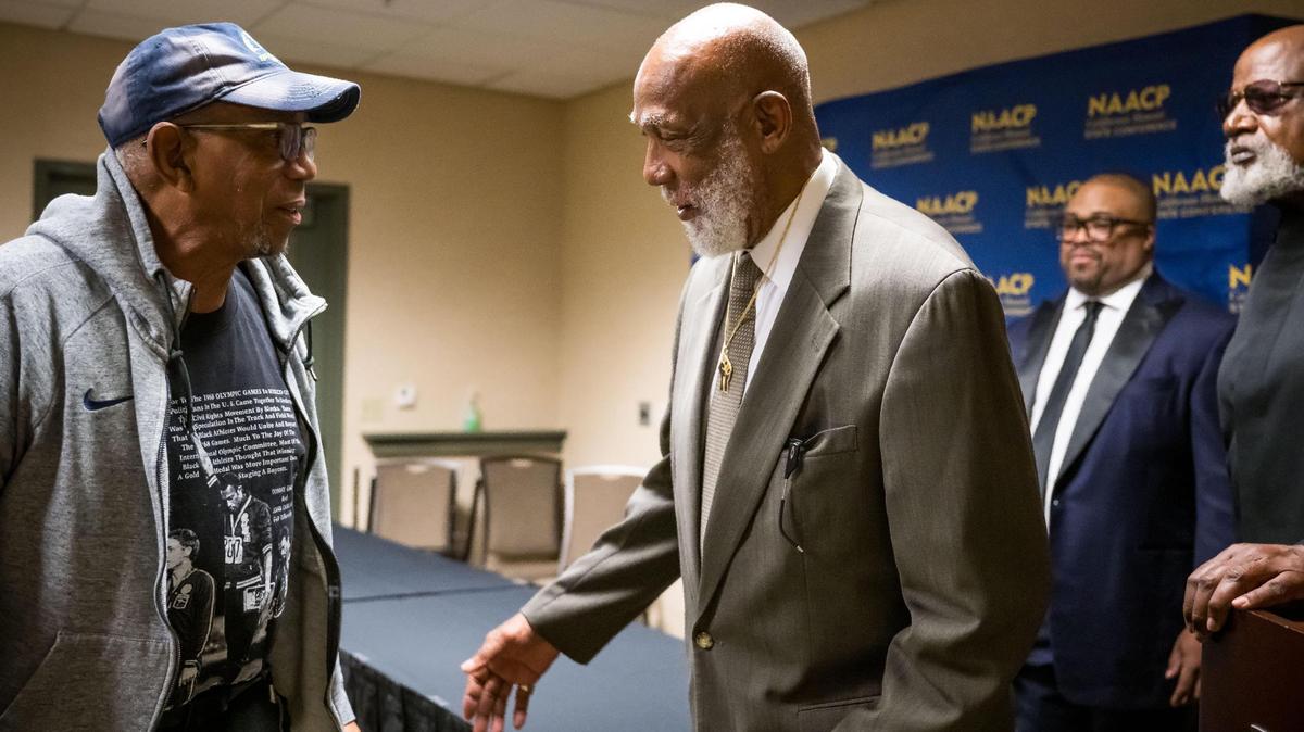 Olympic bronze medalist Dr. John Carlos, right, comments on a shirt — which bears the iconic image in which Carlos is featured— worn by 1967 Olympic Project for Human Rights co-organizer Dr. Kenneth Noel before the California Hawaii State Conference NAACP’s annual Legacy Hall of Fame Ceremony on Saturday, June 24, 2023, at the Sheraton Grand Sacramento Hotel downtown. Along with both men, fellow 1967 Olympic Project for Human Rights co-organizer Dr. Harry Edwards, far right, and Olympic gold medalist Dr. Tommie Smith, not in attendance, were honored at the event.