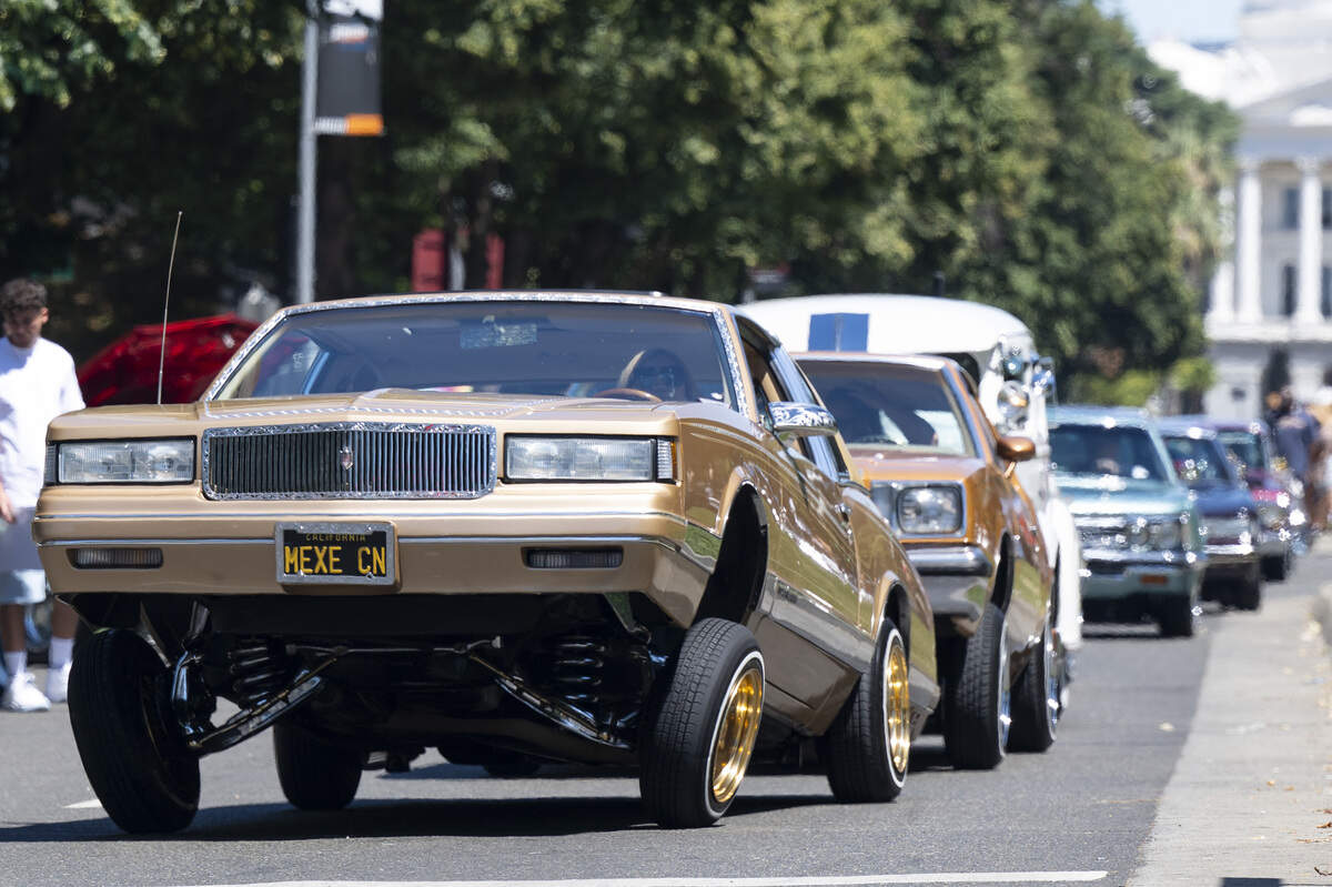 Lowriders cruise along Capitol Mall during the fourth annual Lowrider Holiday Celebration in Sacramento on Sunday, June 21, 2026.