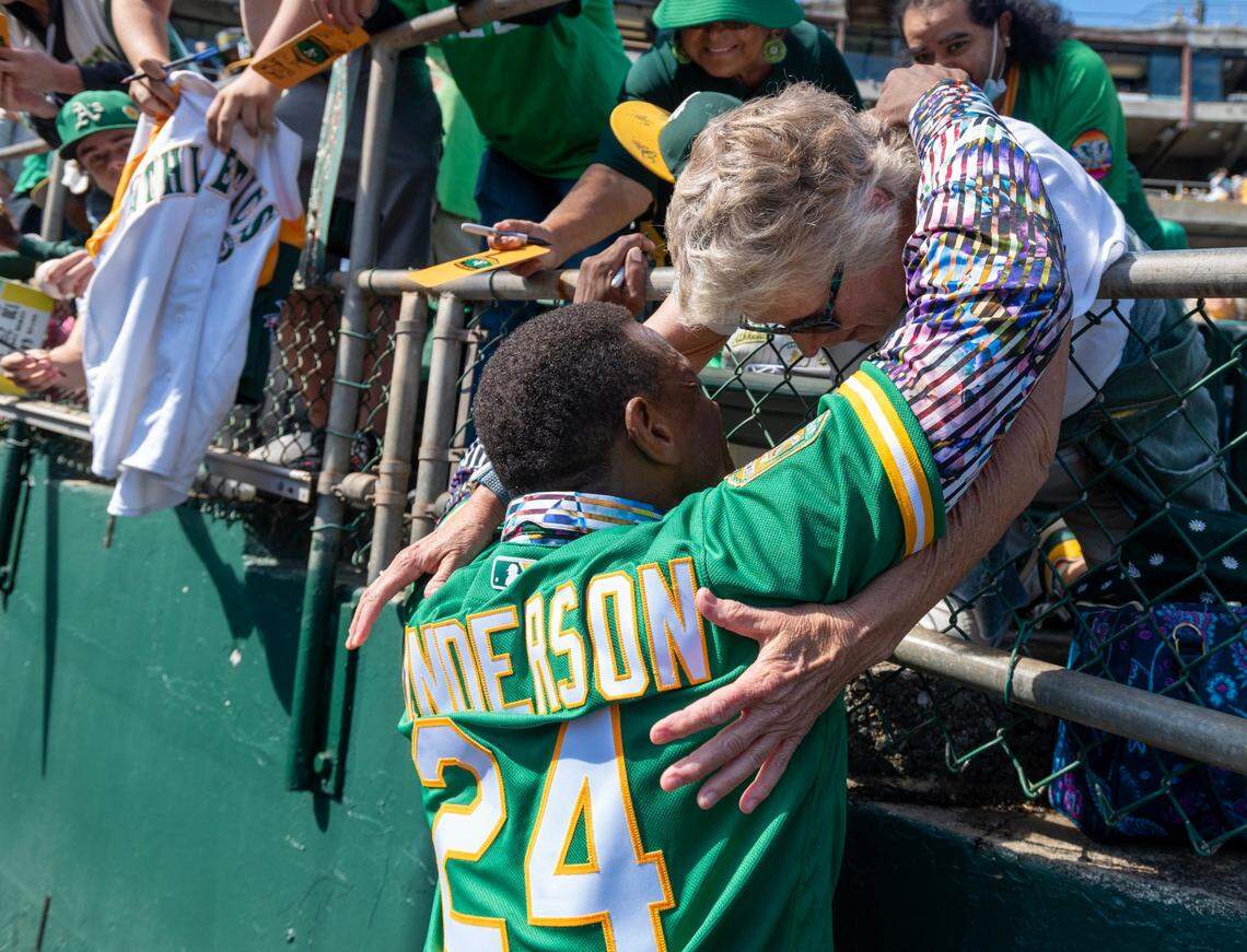 Legendary Oakland A’s player Ricky Henderson hugs a fan before the final home game at Oakland-Alameda County Coliseum on Thursday, Sept. 26, 2024. In 2025, the A’s will play in West Sacramento.