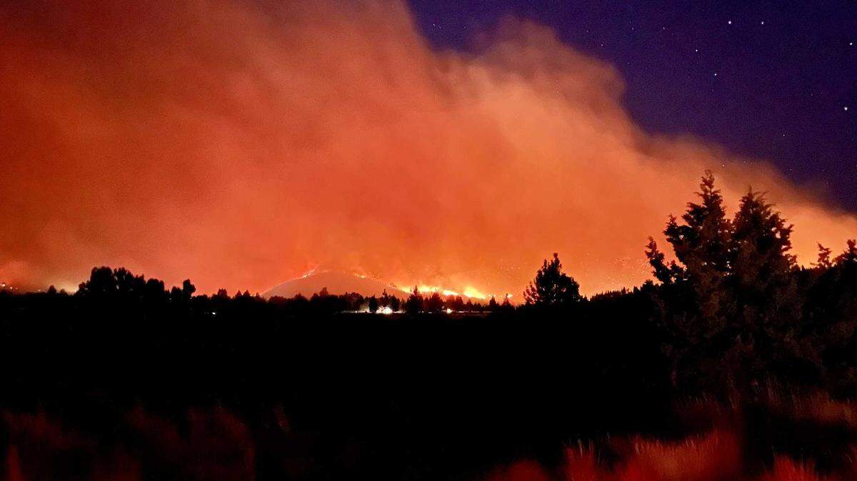 Firefighters work on structure protection for the Bear Fire, which sparked Monday 5 miles south of Loyalton inside the Tahoe National Forest. The fire grew to nearly 1,400 acres by Tuesday morning.