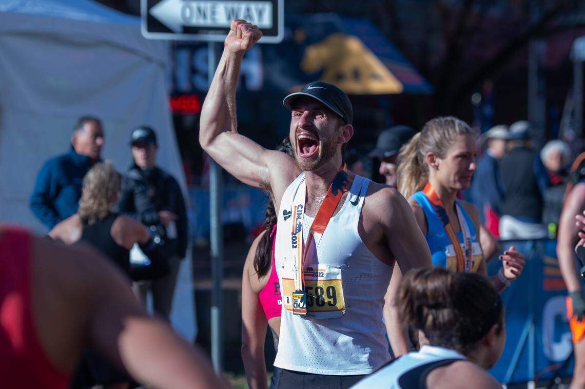 Runner Jordan Newell yells in celebration in downtown Sacramento on Sunday after finishing the 2022 California International Marathon from Folsom to the state Capitol.