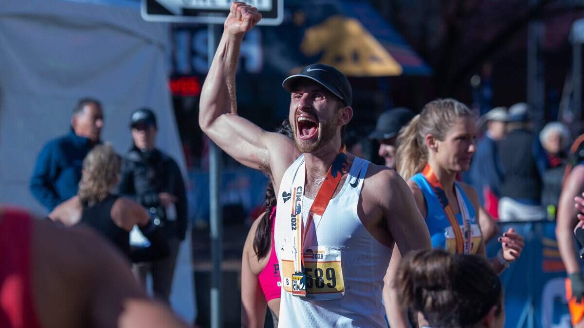 Jordan Newell yells in celebration in downtown Sacramento on Sunday, Dec. 4, 2022, after finishing the 2022 California International Marathon from Folsom to the state Capitol.