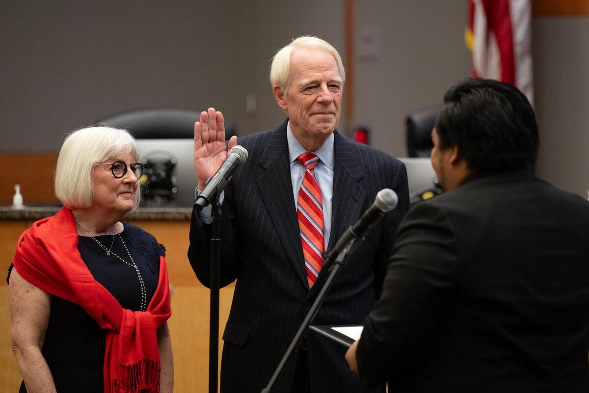Sacramento City Councilmember Roger Dickinson, with his wife Marj by his side, is sworn in at the Sacramento City Council meeting on Tuesday.