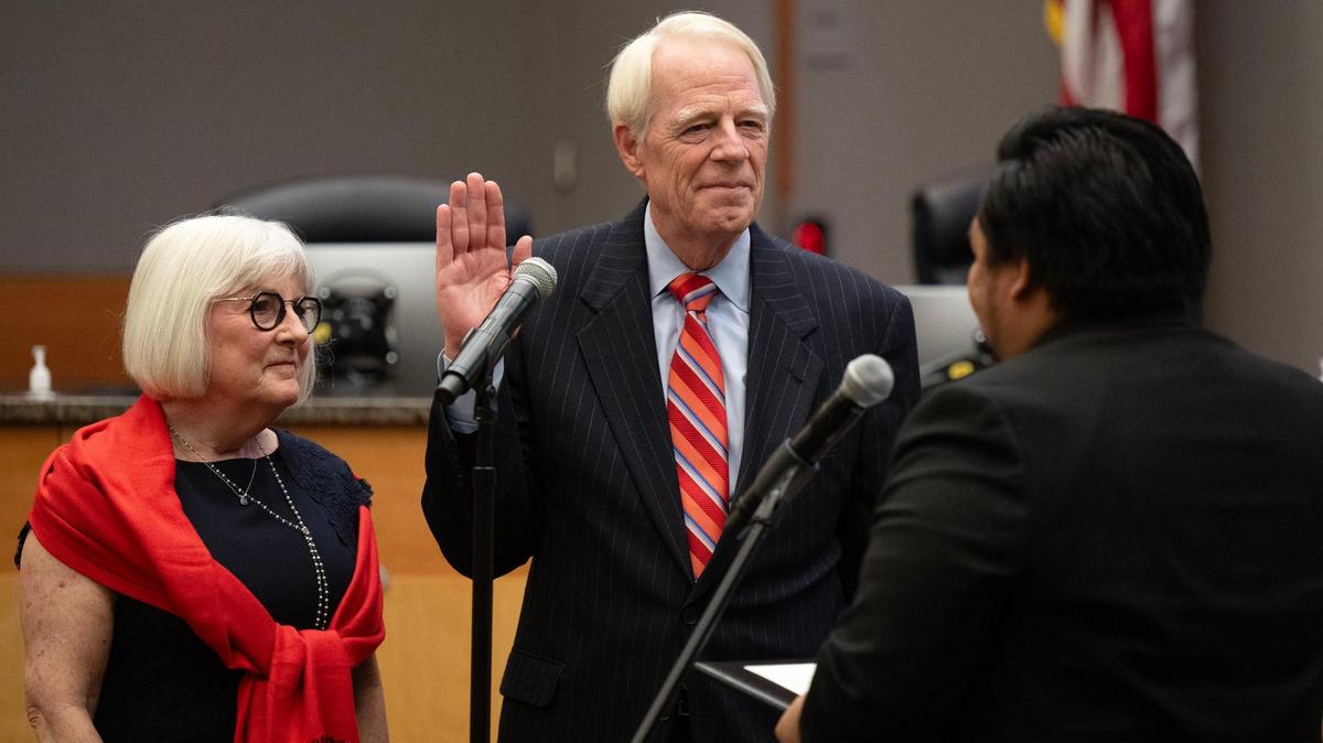 New Sacramento City Councilmember Roger Dickinson, with his wife Marj by his side, is sworn in at the council meeting on Tuesday, Dec. 10, 2024.