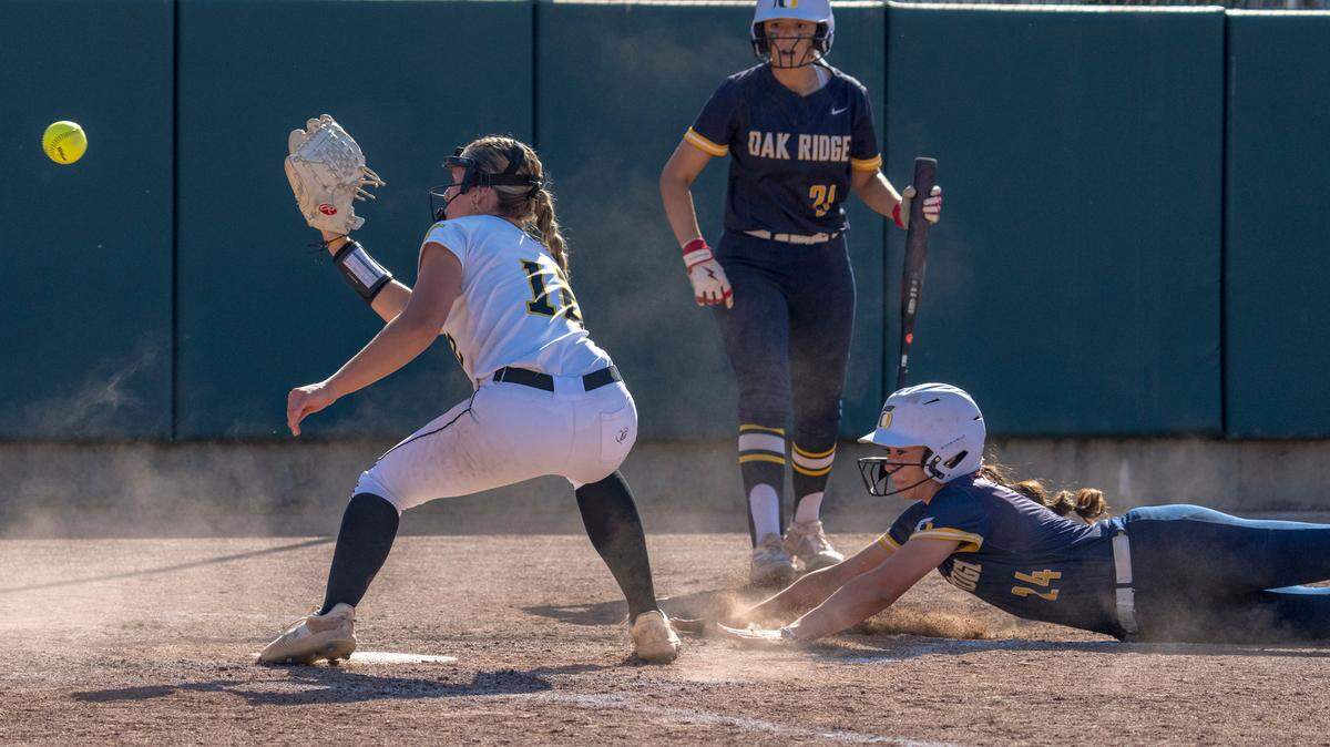 The Del Oro Golden Eagles’ Abby Davidson attempts to tag out the Oak Ridge Trojans’ Carmen Montes de Oca as she scores a run on a passed ball at home during the Sac-Joaquin Section Division I championship softball game at Sacramento State on May 24. Oak Ridge is top-seeded in the D-I Northern California bracket, with Del Oro seeded No. 2.