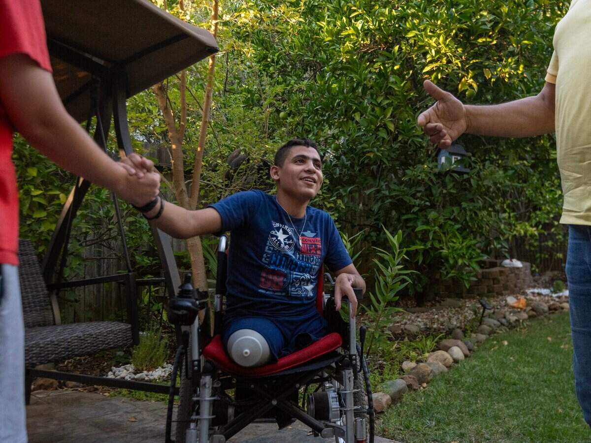 Ahmed, center, talks with his host family in Folsom in September. Ahmed’s mother is worried about him returning to Gaza since his family is living in tents with no electricity.