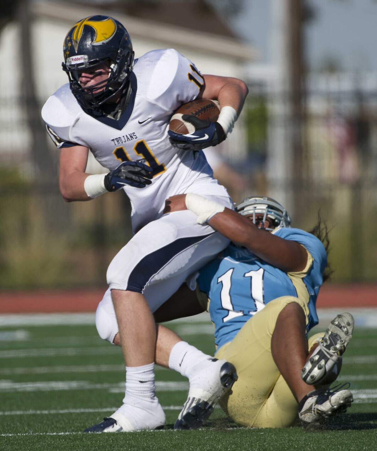 Oak Ridge High School’s Ross Dwelley (11) makes a first down catch and run before he is stopped by Burbank High’s Sateki Polaulu (11) during the Division I semifinal playoff game on Saturday, Nov. 24, 2012, in Sacramento.