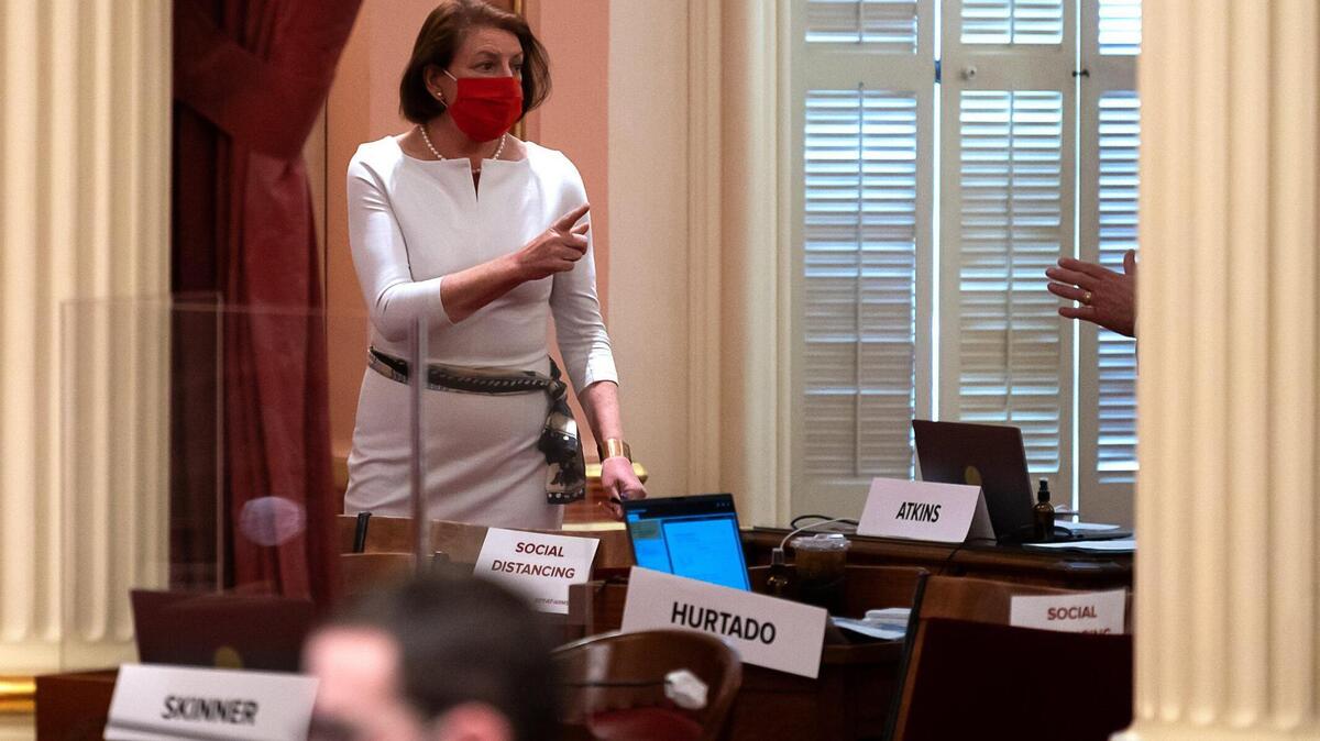 President pro Tempore Toni Atkins, D-San Diego speaks with Jim Nielsen, R-Gerber at the State Capitol on Thursday, Aug 27, 2020, in Sacramento. California Republican state senators will be tested for COVID-19 after GOP lawmaker Brian Jones disclosed he was infected with the coronavirus.