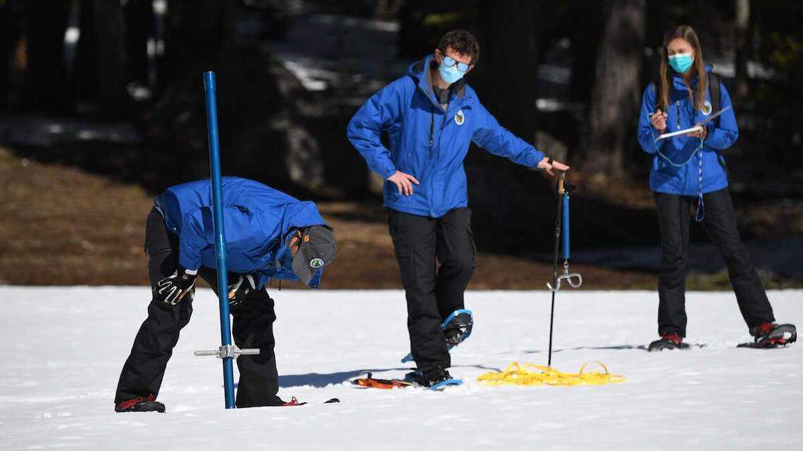Sean de Guzman, left, snow survey manager with the California Department of Water Resources, measures the snowpack Tuesday, March 1, 2022, at Phillips Station, Calif., near Echo Summit. DWR officials said Californiaâs drought will continue amid below-average snowpack and reservoir levels.