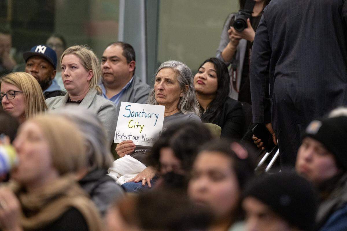 Nancy Bean of Sacramento holds a sign supporting Sacramento's sanctuary city status during a City Council meeting on Tuesday.