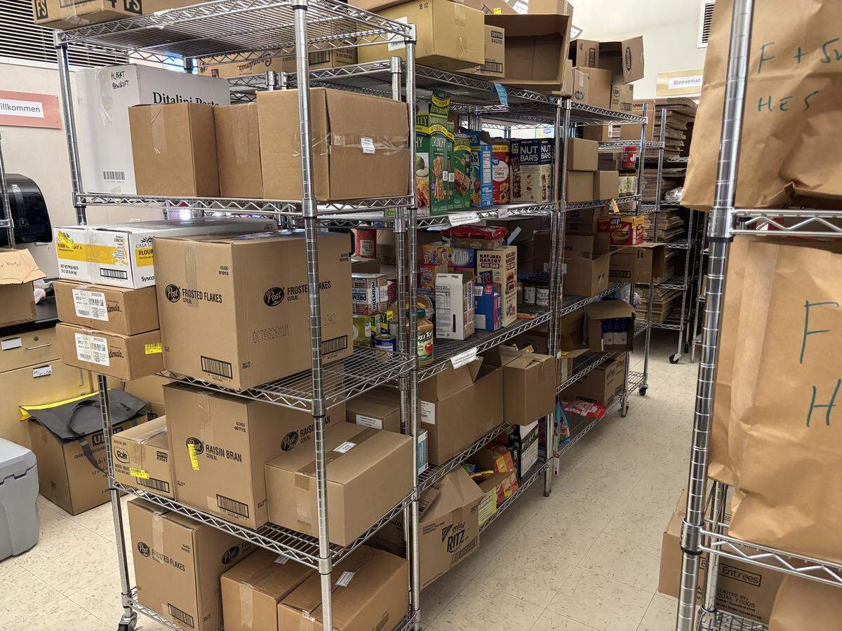 A food distribution program is operated by Alchemist CDC from a room the Sacramento City Unified School District’s student enrollment center.