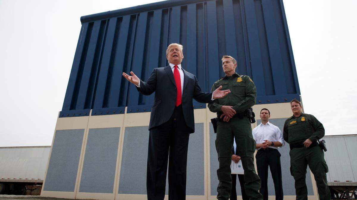 President Donald Trump talks with reporters in March as he reviews border wall prototypes in San Diego. He wants to deploy the National Guard to help Border Patrol agents along the U.S.-Mexico border.