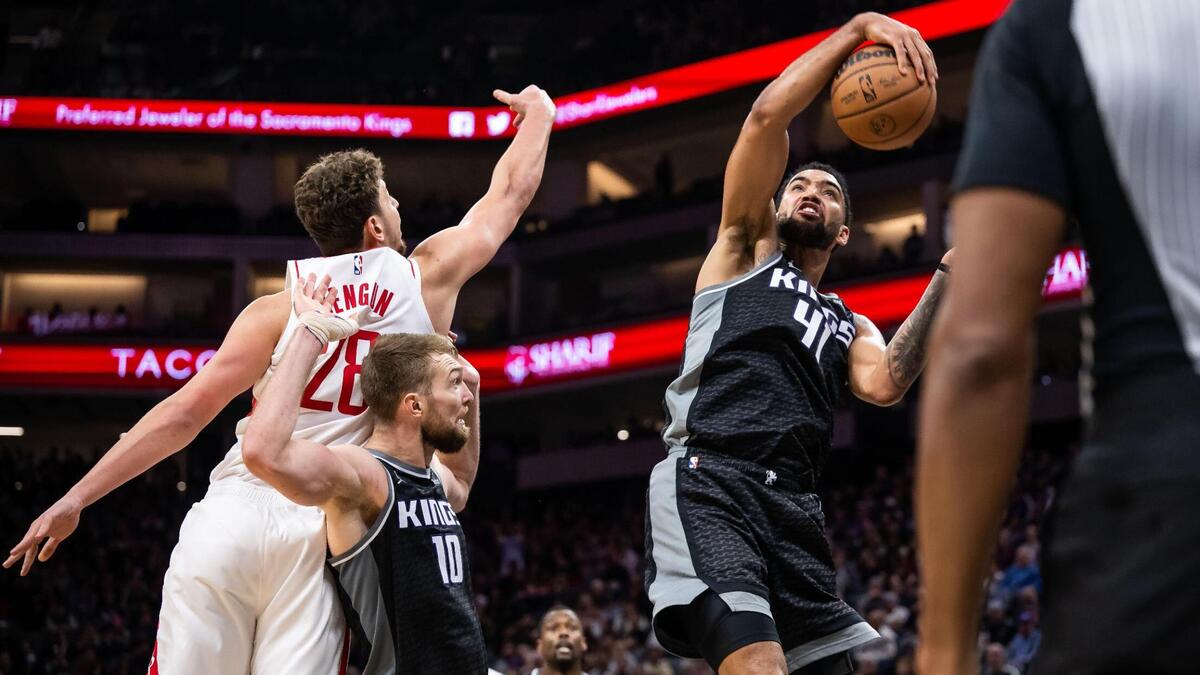 Sacramento Kings forward Trey Lyles (41), right, grabs a rebound on defense as teammate Domantas Sabonis (10) runs interference on Houston Rockets center Alperen Sengun (28) during the fourth quarter at the NBA basketball game Wednesday, Jan. 11, 2023, at Golden 1 Center in Sacramento. The Kings beat the Rockets, 135-115.