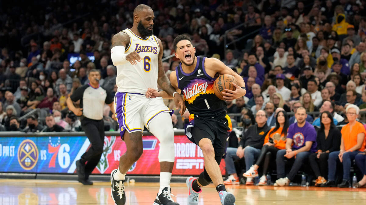 Phoenix Suns guard Devin Booker (1) during the first half of an NBA basketball game against the Los Angeles Lakers, Sunday, Jan. 13, 2022, in Phoenix. (AP Photo/Rick Scuteri)