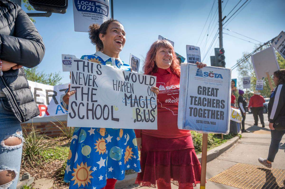 Angela Chatman and Stacey Willett, both special education teachers at Luther Burbank High School, attend a teachers strike rally and march at Hiram Johnson High School on Tuesday.