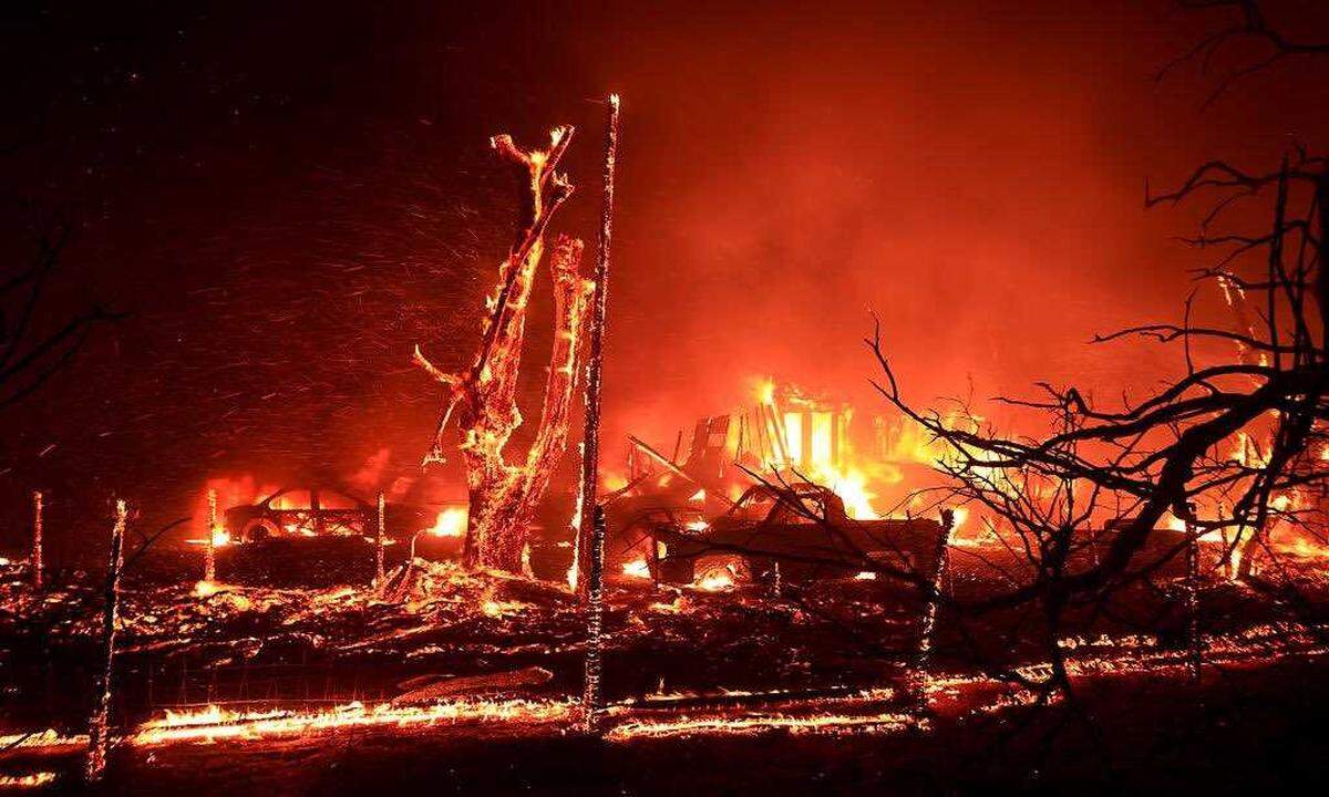 A home burns Saturday in the Corral Fire at Bernard and Stearman roads, west of Tracy. The wildfire exploded to more than 12,000 acres burned several structures and shut down an interstate freeway southwest of Tracy. Evacuation orders remain in place.