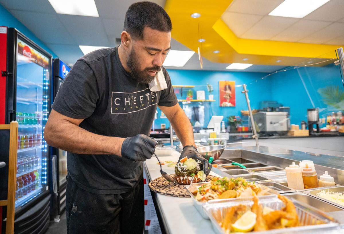 Muagututia Tuala-Tamaalelagi, chef and owner of Fresh Off Da Boat by Chef T, prepares Lau Lau on Casava Cake on Tuesday, Feb. 6, 2024.