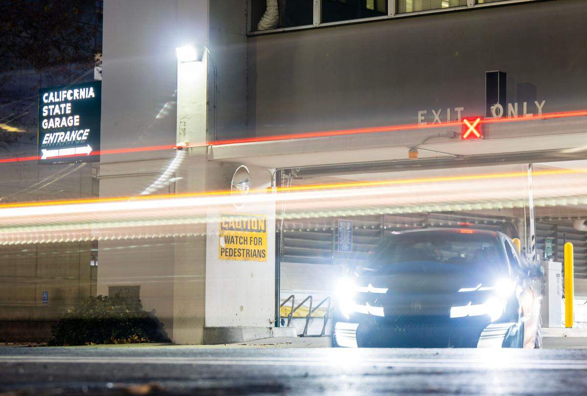 A state worker waits to exit the California State Garage, where monthly parking passes are highly prized, on 10th Street in downtown Sacramento earlier this month.