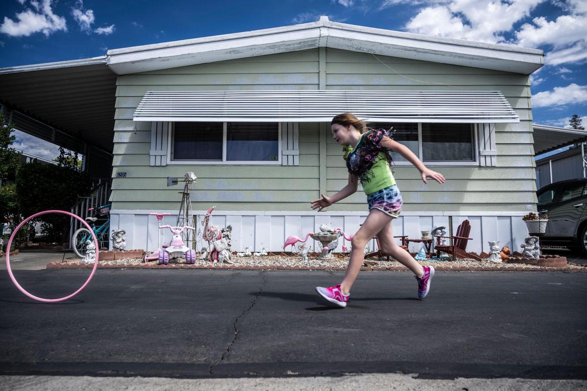 Mary Page plays outside with a hula hoop in August. Residents, including Page’s mom, say management is harassing them with evictions threats over minor infractions at the park and has created a “culture of fear.”